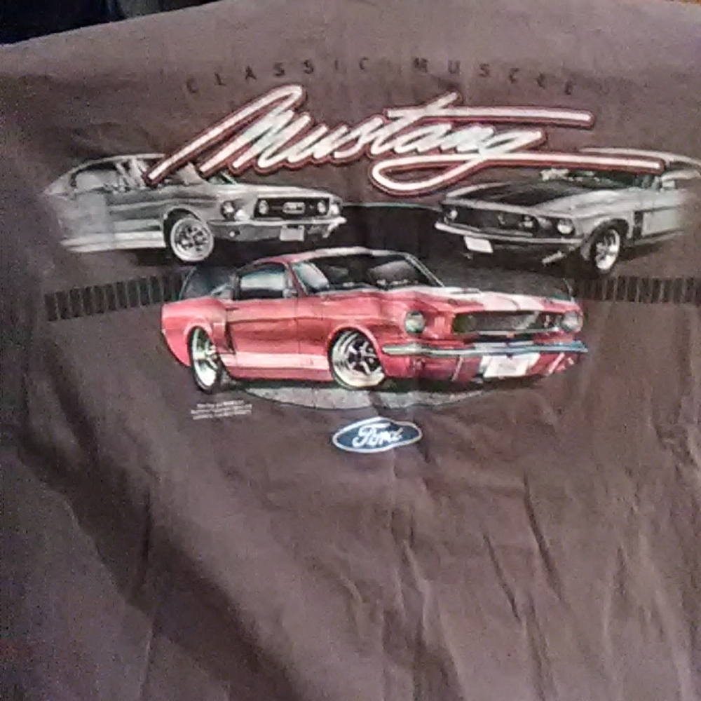A shirt with MUSTANG CAR 'S on it.